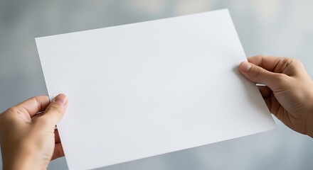 Obraz premium Hands holding plain white paper
