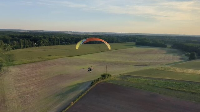 Motorized powered paragliding aerial view showcasing outdoor aviation sport and scenic landscape