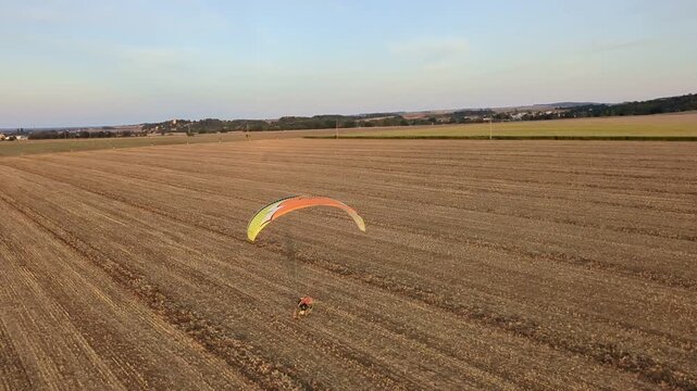 Motorized powered paragliding aerial view showcasing outdoor aviation sport and scenic landscape
