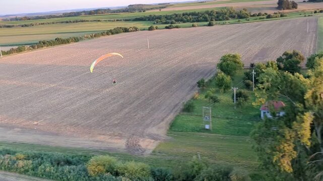Motorized powered paragliding aerial view showcasing outdoor aviation sport and scenic landscape