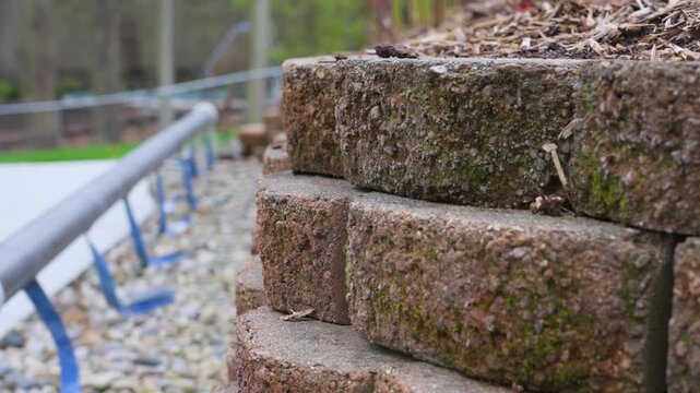 Slow motion view at ground level of a retaining garden wall.