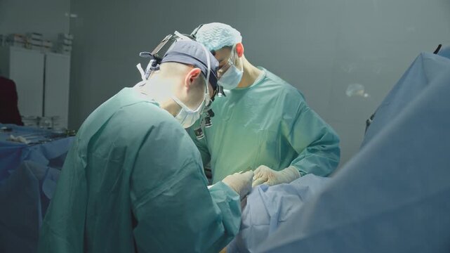 Clinical team two men doctors surgeons processing cardiac surgery operation surgical operate therapists males with scalpel cutting emergency medicine operating health tumor removing cancer disease