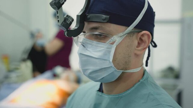 Surgeon doctor man in medical uniform protective mask glasses working operation male practitioner physician work in hospital clinic surgery neurosurgeon emergency medicine health diagnosis medicare