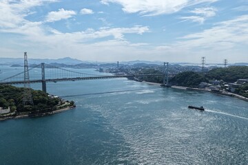 Fototapeta premium Aerial drone photo of Kanmon Bridge and Kanmon Strait, Kitakyushu, Japan