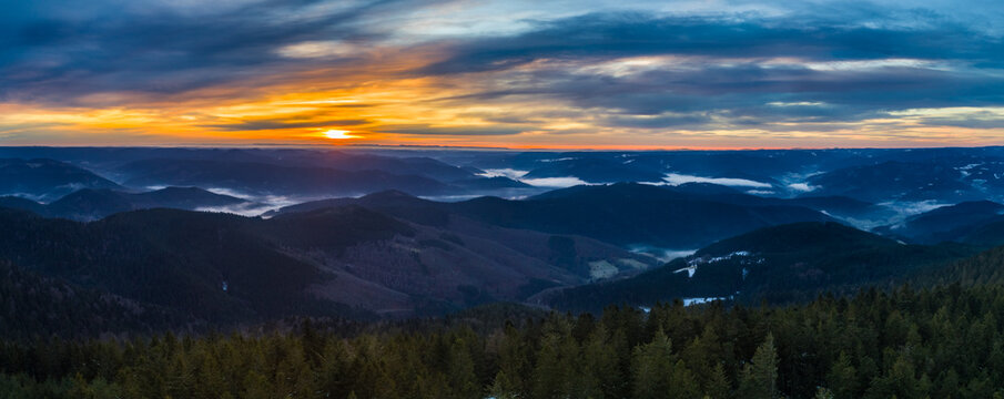 Panoramic sunrise view from Brandenkopf over Black Forest valleys with fog inversion and Alps silhouette, Baden-W&uuml;rttemberg Germany