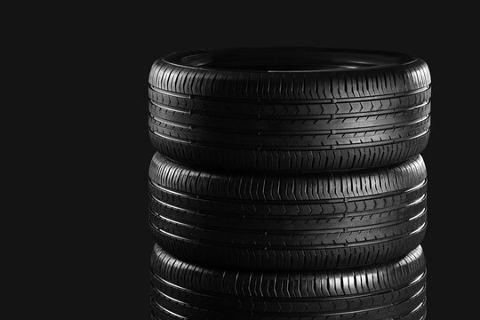 Stack of car tires on dark background