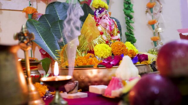 ganesh chaturthi celebration with blurred sweet offerings and sacred items