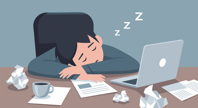Man falls asleep at desk with laptop and papers scattered around him