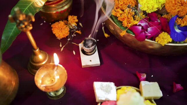 hindu puja ritual with burning diya and incense during devotional worship