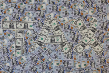Fototapeta premium Word TAX made of one dollar bills on hundred US dollar banknotes background