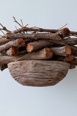 Fototapeta premium Rustic stack of cut logs with a carved wooden bowl for natural display background and wood decor composition