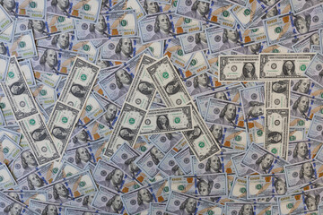 Fototapeta premium Word VAT made of one dollar bills on hundred dollar banknotes background