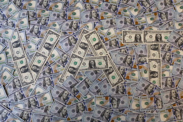 Fototapeta premium Word VAT made of one dollar bills on hundred dollar banknotes background