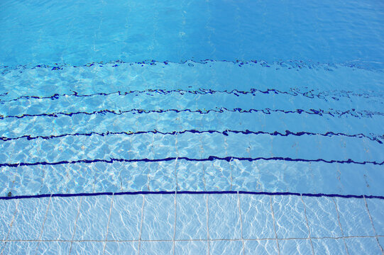 Blue pool filled with water in Summer