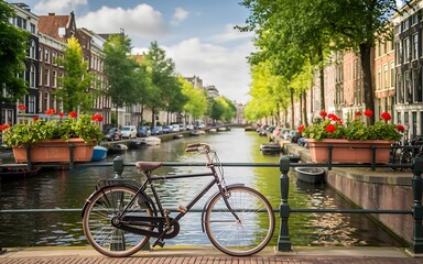 Obraz premium Bicycle on canal bridge, Amsterdam cityscape, tulip flowers, urban cycling