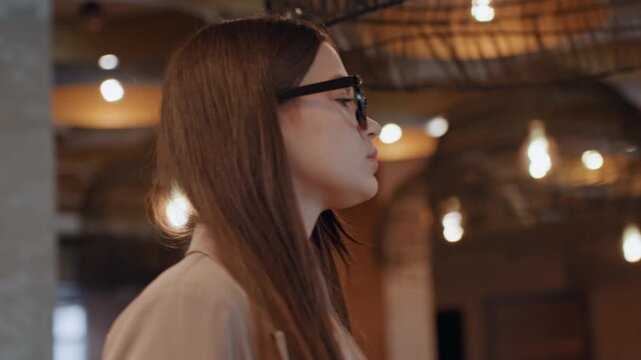 Stylish woman confidently approaches door. Caucasian woman with elegance heads toward entryway assertively. Selfassured woman dressed fashionably moves gracefully toward door in composed manner