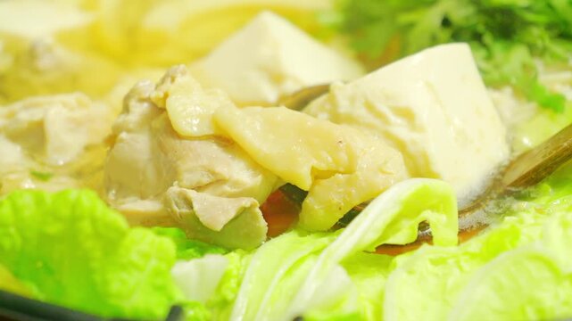 Close-Up Video of Japanese Hot Pot with Chicken, Tofu, and Napa Cabbage
