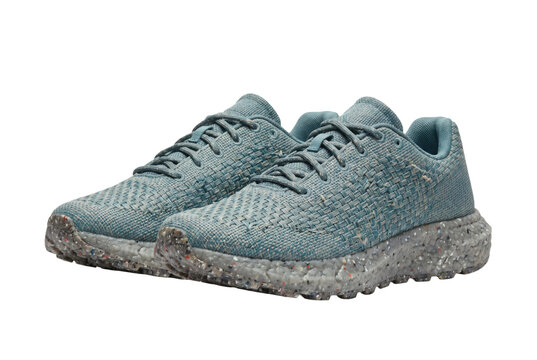 Modern sneakers crafted from recycled ocean plastic with woven texture and recycled rubber sole isolated on white background. Sustainable footwear and eco lifestyle concept.