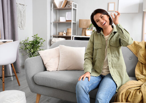 Young girl with ear drops at home