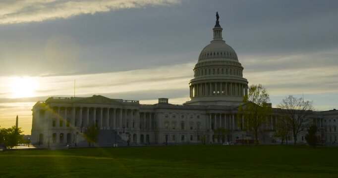 US Capitol Building Near Sunset with Washington Monument Silhouetted in Distance