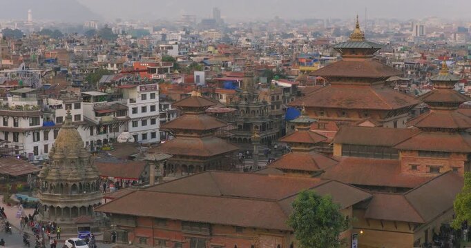 Drone shot of Patan Durbar Square, UNESCO Heritage, Lalitpur, Nepal Malla Dynasty palace structures, traditional Newari architecture, pagoda temple, historic monuments near the urban landscape.