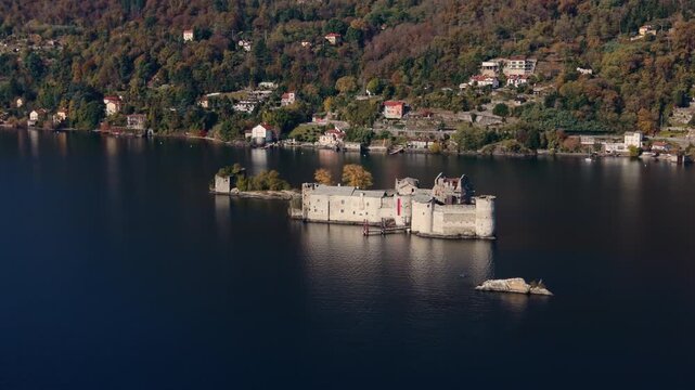 Aerial: establishing drone shot of Castelli di Cannero, three rocky islets, during the day with Lake Maggiore in northern Italy, Europe