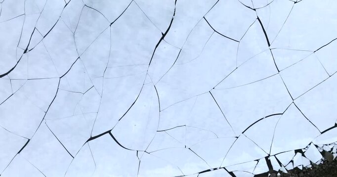 Stortvatnet lake on Austvagoya in Vagan Nordland Norway shows thermal contraction cracks across frozen surface forming polygon network with subtle reflection, ascending top down drone barrel roll