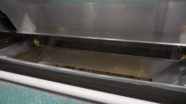 Industrial food mixing machine processing dough or flour material in stainless steel container at food factory