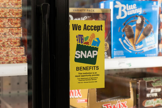 SNAP and EBT Accepted here sign. SNAP and Food Stamps provide benefits to help the budgets of disadvantaged families.