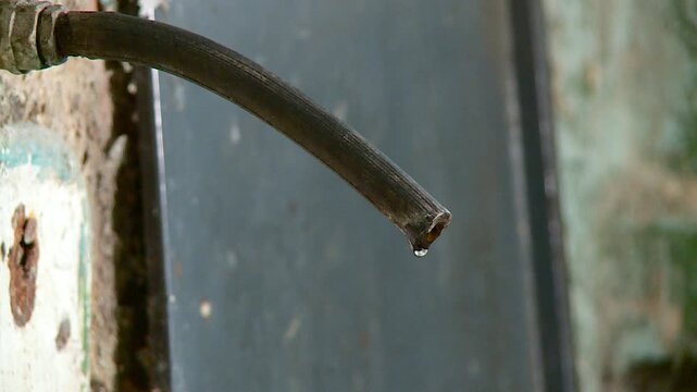 water drips from the faucet in the slums
