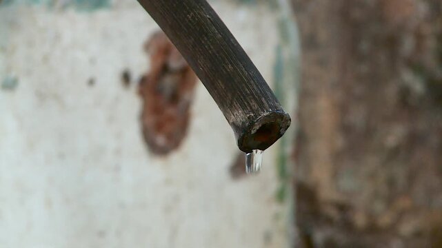 water drips from the faucet in the slums