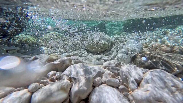 Spectacular images of the Torre River's whirlpools in Friuli. Above and below the water. The wild nature of the Julian Prealps.
