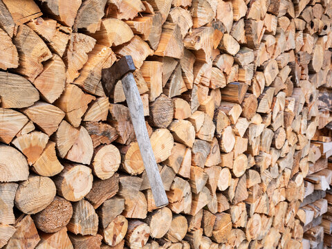 Stack of firewood with an old hatchet