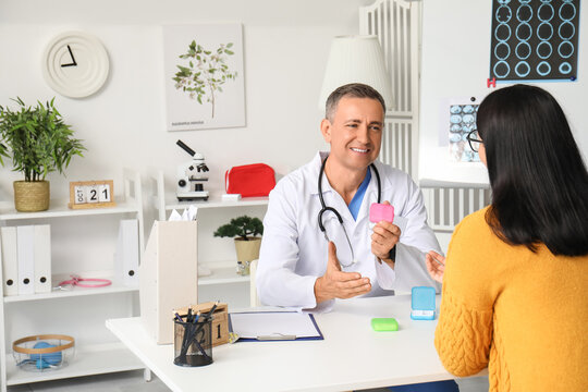 Mature doctor prescribing pills to patient in clinic