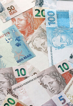 Brazilian real money banknotes pile on table. Brazil bills of BRL currency. Concept of economy