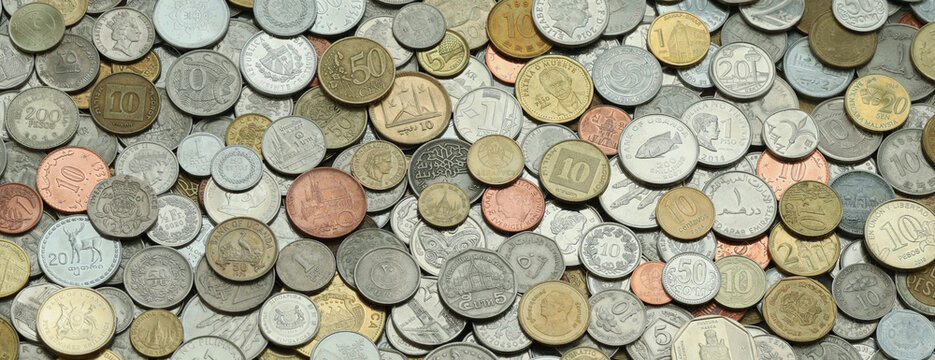 Scattered coins of multiple origins in big mound, detailed shot. World currency variety