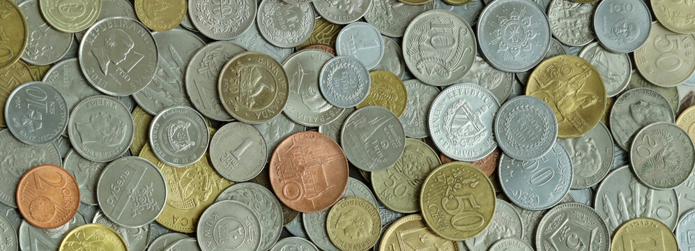 Scattered coins of multiple origins in big mound, detailed shot. World currency variety