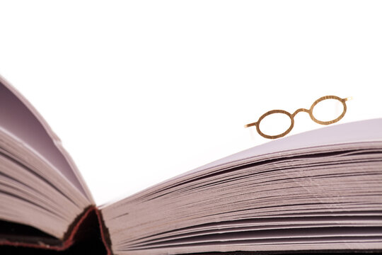 Reading glasses on book edge