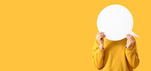 Young woman holding blank speech bubble on yellow background with space for text © Pixel-Shot