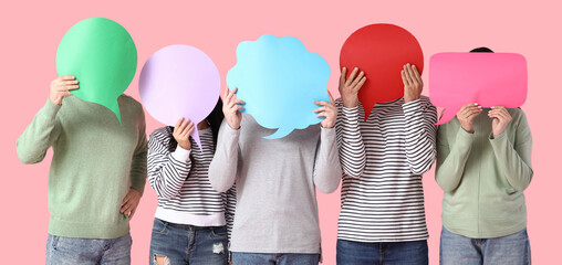 Group of people with blank speech bubbles on pink background