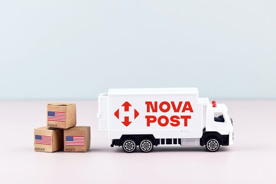 A white toy truck with the NOVA POST logo and boxes on a light background.