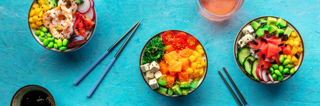 Poke bowl panorama. Rice with salmon, shrimps, and grapefruit, overhead shot