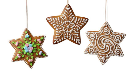 Fototapeta premium Three decorative gingerbread cookies shaped like stars hanging isolated on transparent background