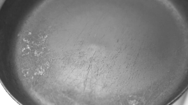 pour oil into a hot frying pan on an electric stove