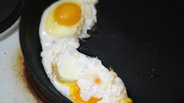 making fried eggs for breakfast