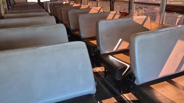 Inside view of seats in a prison bus Blue Bird of M.S.D.O.J. with bars on the windows, front view