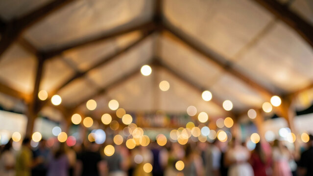 Elegant event reception under a tent with warm bokeh lights