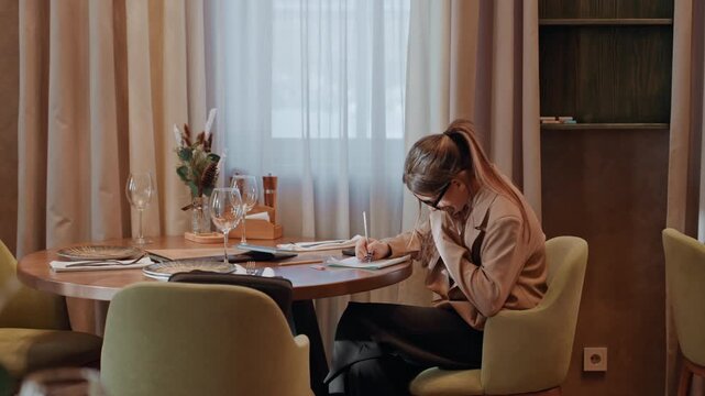 Young woman experiences weariness after analyzing financial documents and receipts. Female reviewer feels exhausted following thorough examination of payment slips and billing statements