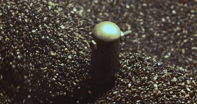 Roasting Sand for Chestnuts in a hot pan, close-up. rolling and heating. Ideal for food, snack, street food, and cozy winter concepts