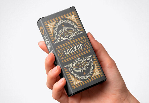Hand holding blank rectangular box packaging